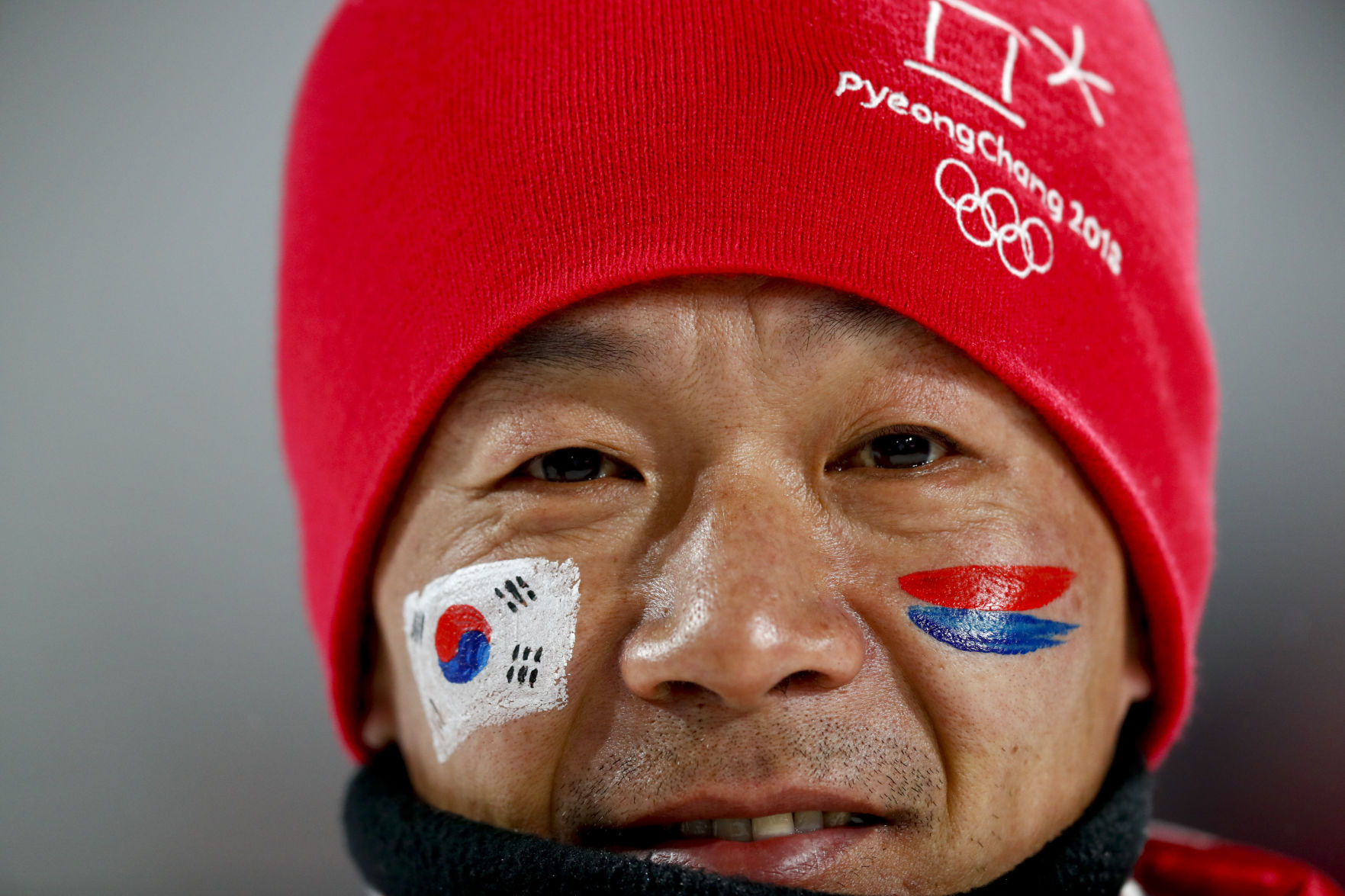 A fan watches the women's normal hill individual ski jumping competition
